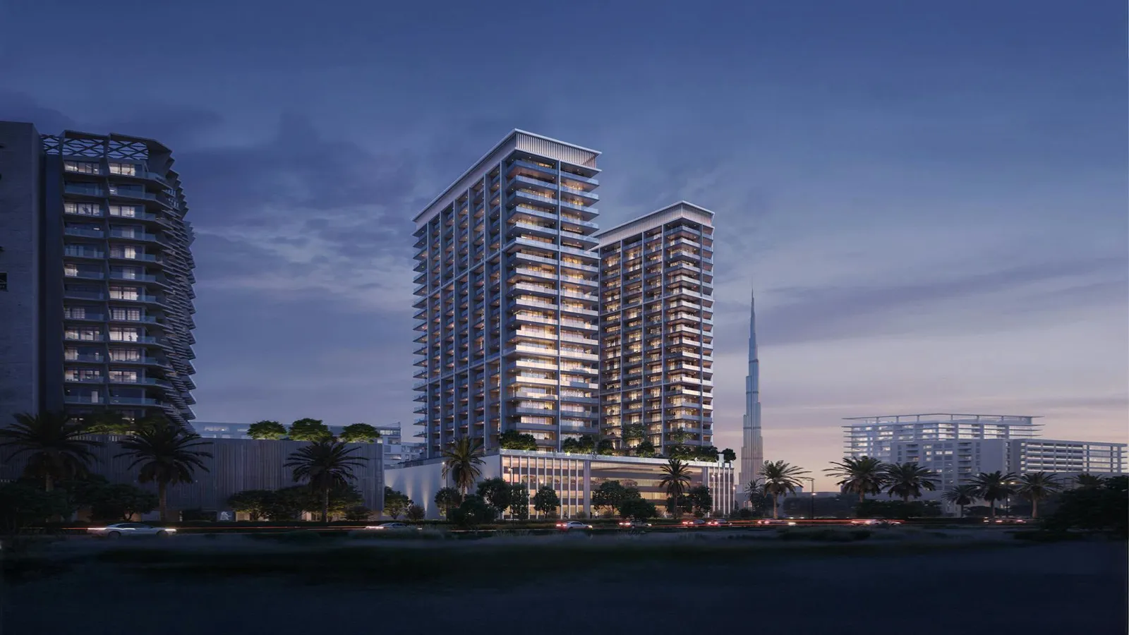 Binghatti Ghost ikiz kuleleri alacakaranlıkta, arkada Burj Khalifa